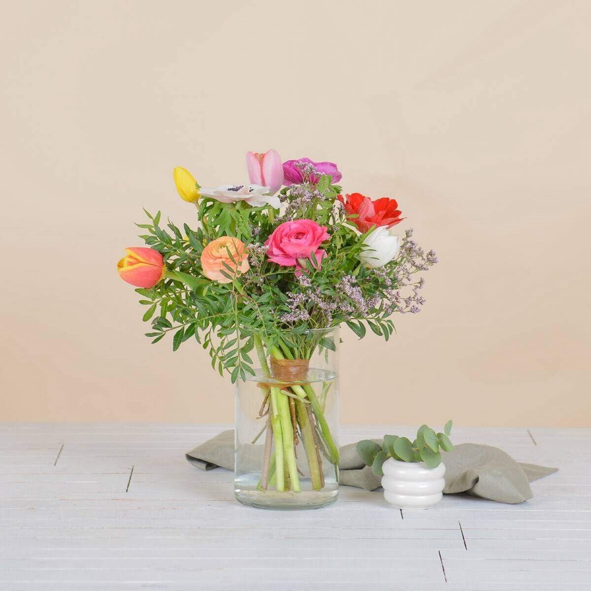 flower bouquet, glass vase, mixed flowers, tulips, greenery, flower bouquet, mixed flowers, glass vase, green stems, pastel colors, flower bouquet, tulips, roses, mixed greenery, glass vase